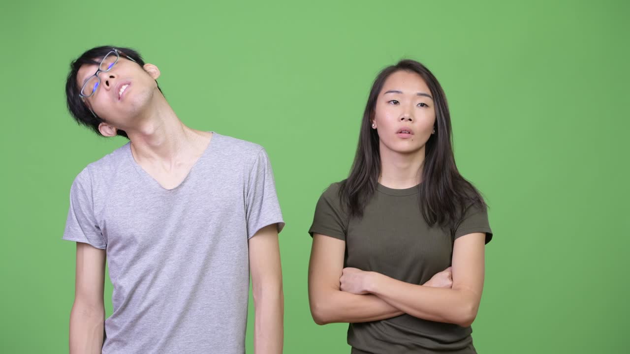 Young Asian couple looking bored together