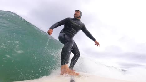 surfer surfing tropical ocean wave. slow motion