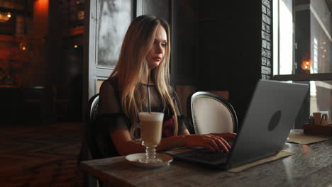 Hermosa-Mujer-Hipster-Usando-Laptop-En-El-Café