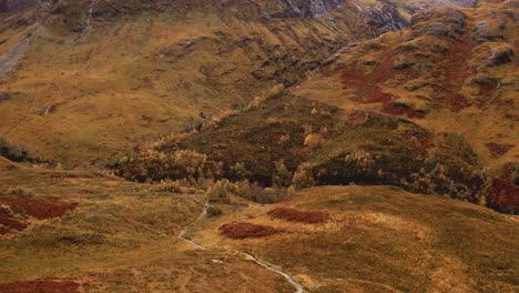 AERIAL---High-angle-view-of-the-Scottish-Highlands,-Glencoe,-Scotland,-wide-shot