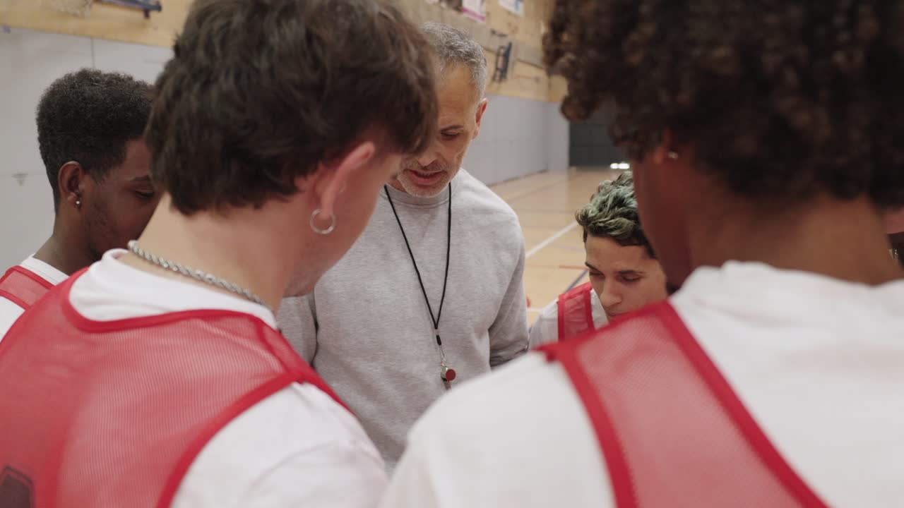 Basketball team having a discussion with their coach