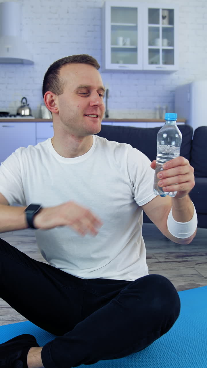 Man on floor at training. Young man practicing fitness with online training on laptop