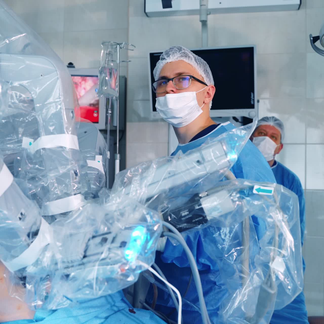 Doctors control the robotic surgery. Modern medical device performing an operation to a patient. New technology in surgery.