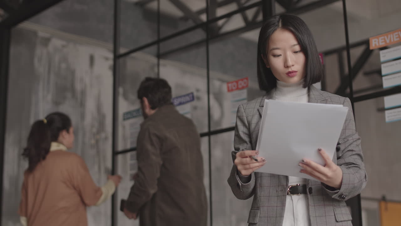 Asian Businesswoman Posing with Papers