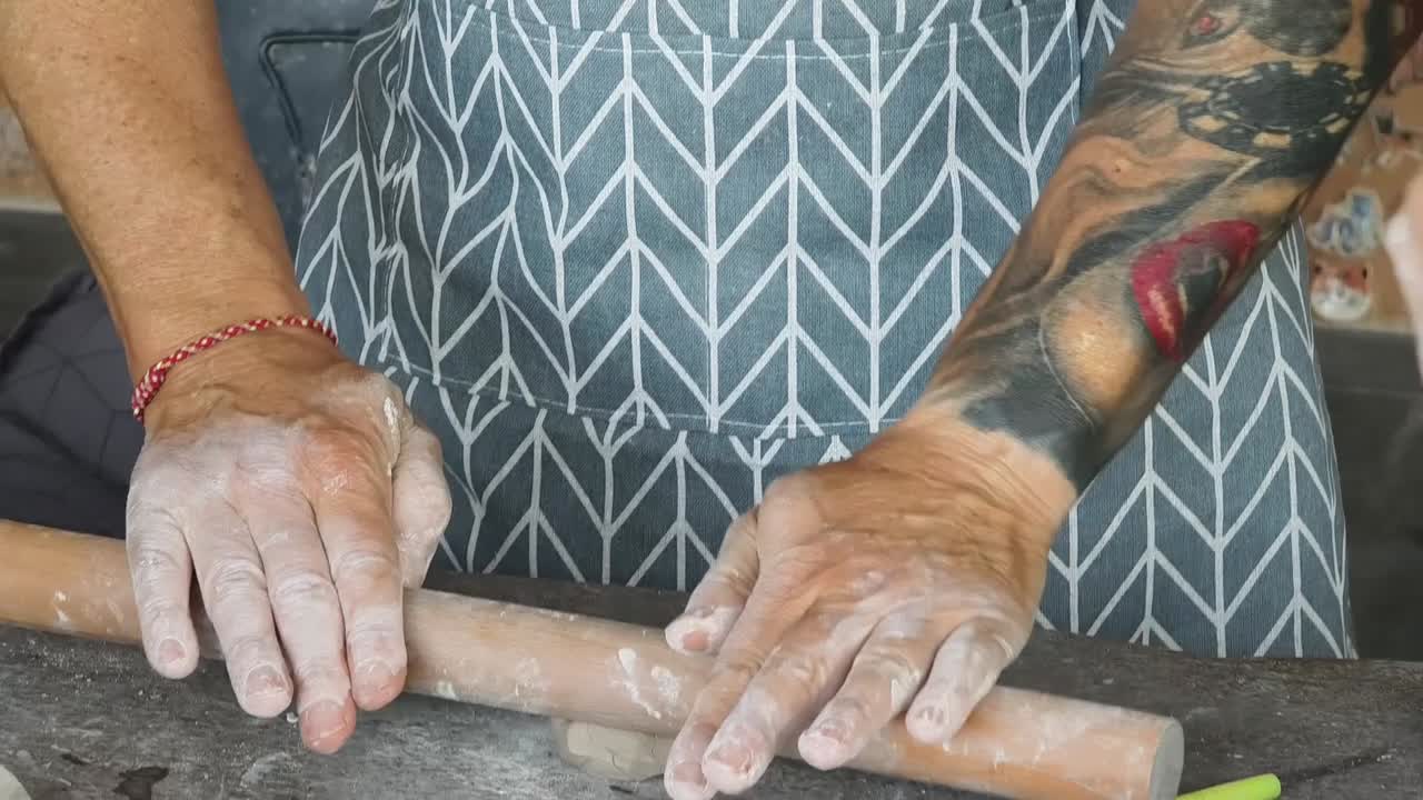 Close-up of Hands Kneading and Rolling Clay in a Pottery Workshop