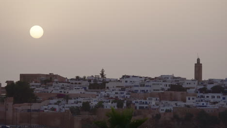 Sun-disc-over-the-old-city-with-a-minaret,-Rabat-Morocco