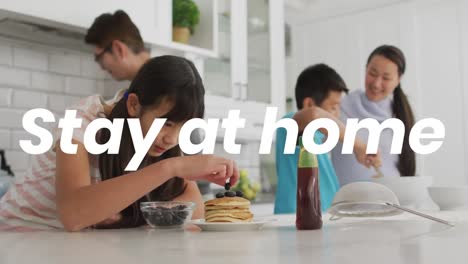 animation of stay at home text over happy asian family at home