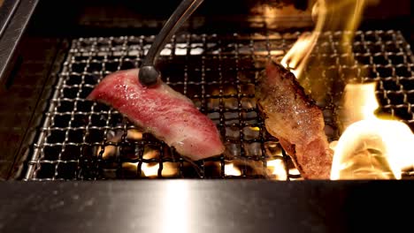 grilling beef strips on a wire mesh over fire