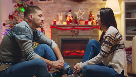 married couple celebrating christmas with their cute cat