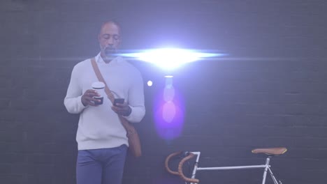 animation of light spots over african american man using smartphone