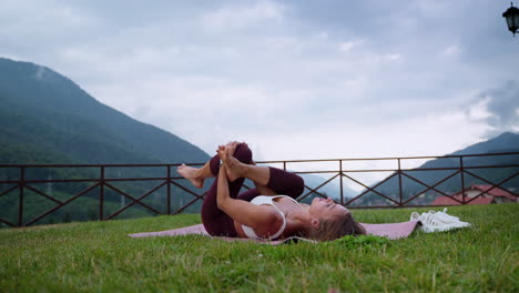 woman practicing yoga outdoors in a mountain landscape