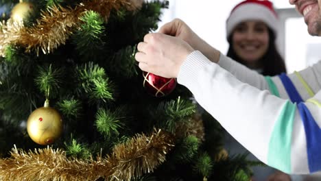 Couple Decorating Christmas Tree for the Holidays