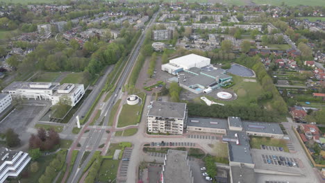 flying up to indoor swimming pool with solar panels on rooftop and a solar panel field