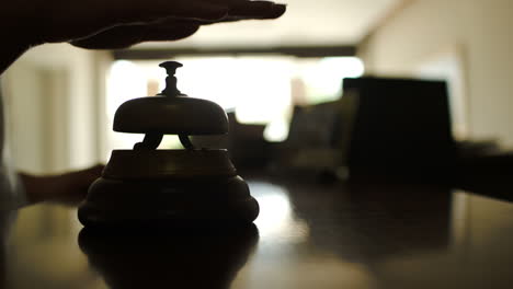 Woman-ringing-reception-bell-in-hotel