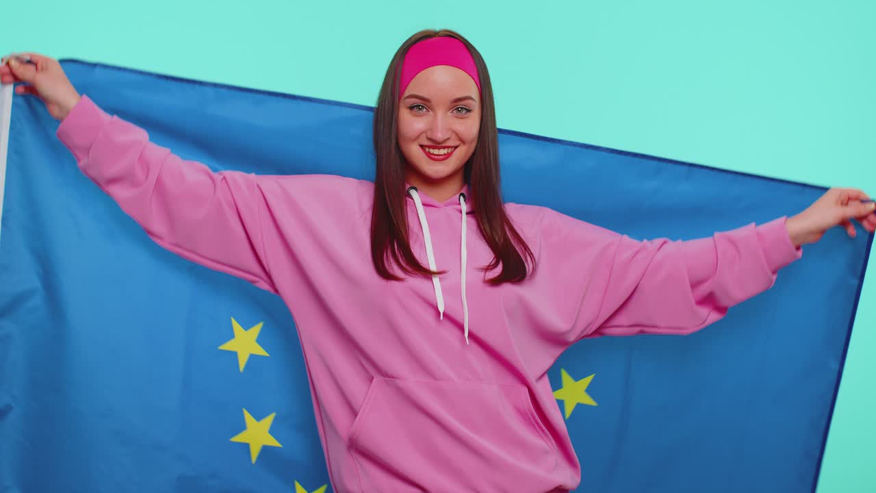 Pretty teen girl waving european union flag smiling cheering democratic laws human rights freedoms