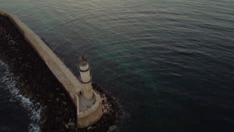 lighthouse in port with sunset