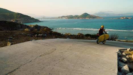 man on motorcycle with surfboard heading to sea beach for calm summer vacation