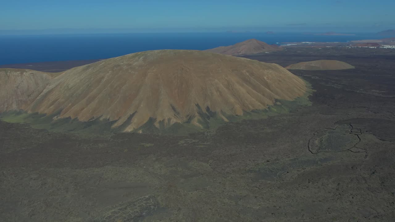 Aerial drone view of mountain sea and volcanoes in Lanzarote, Canary Islands, Spain