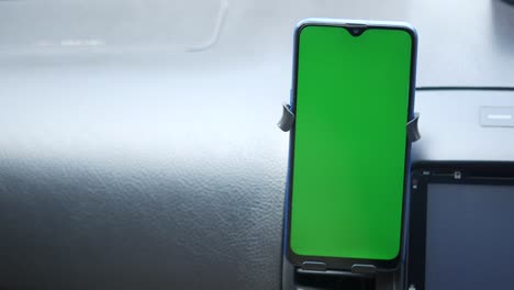 smartphone in car mount with green screen