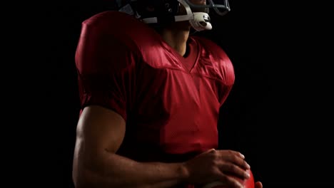 American-football-player-holding-a-ball-with-both-his-hands-4k