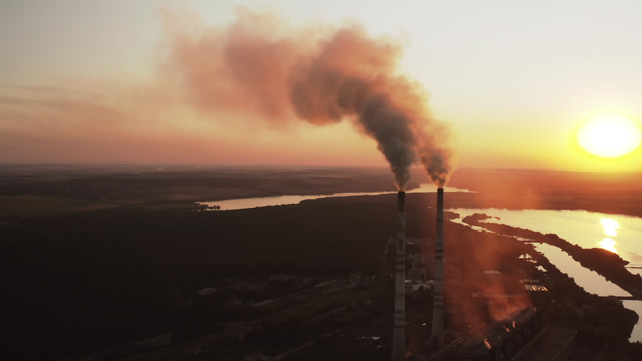 Environmental problem of pollution ecology. Aerial view of high chimney pipes with smoke from power plant