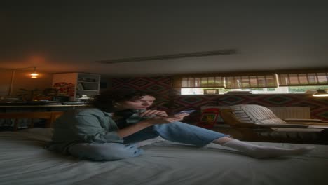 woman using phone in a bedroom