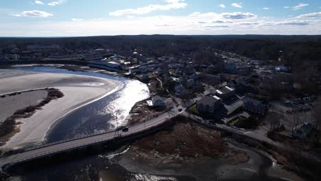 Gentle-waters-in-a-coastal-inlet-with-ocean-tides-reflecting-an-afternoon-sun-near-a-seaside-village