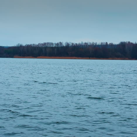 cold late autumn day on the big river. grey waterscape reflecting overcast skies above.