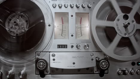 reel-to-reel tape recorder with spinning analog tape reels