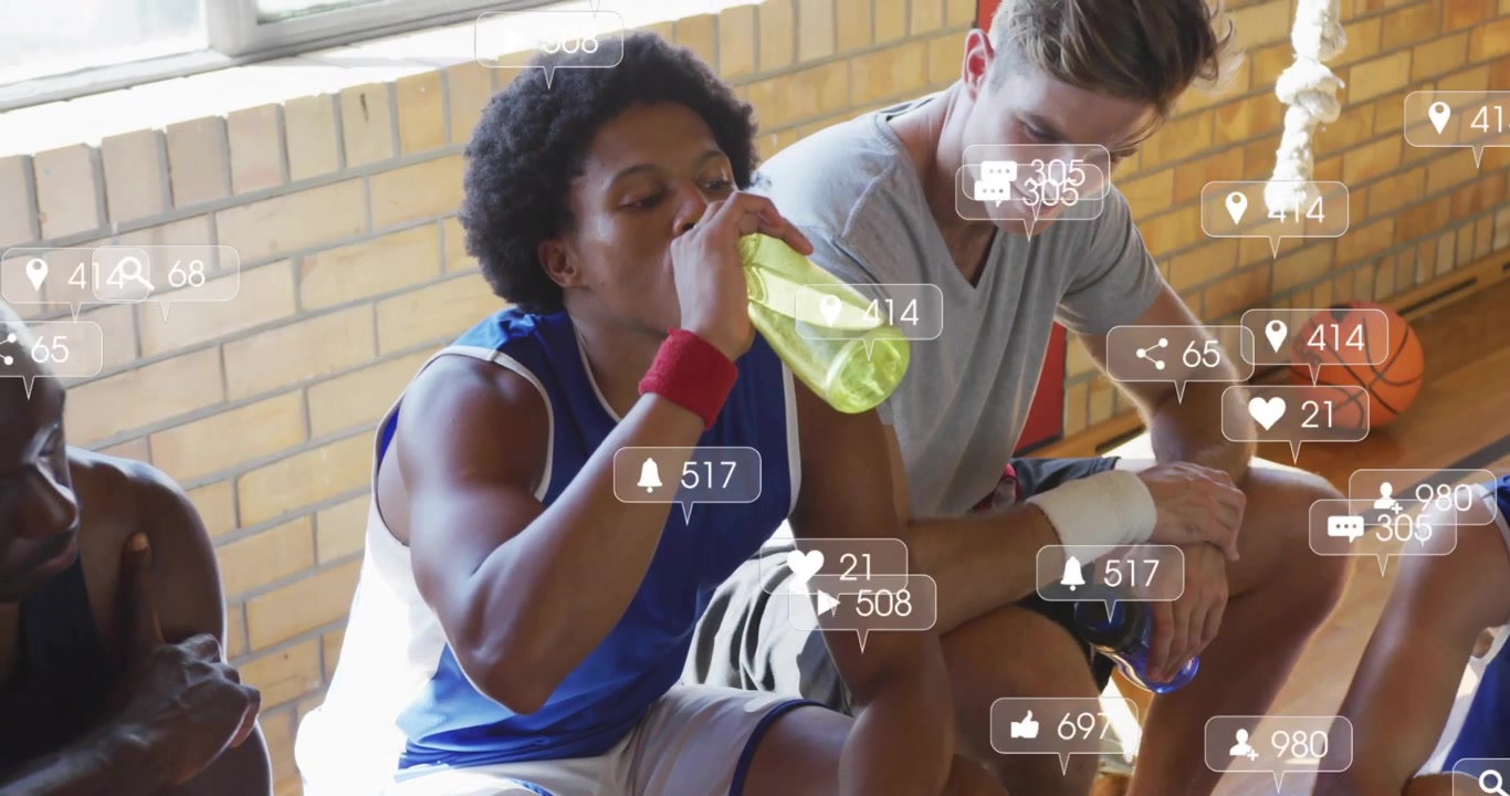 Drinking player in blue jersey sipping on break on gym bench with green bottle, social overlays