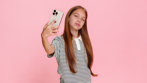 child girl kid happily taking funny selfies on smartphone laughing joyfully making playful faces
