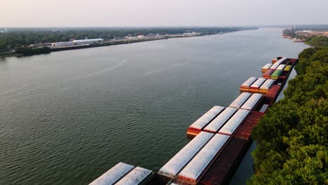 aerial view over storage containers, at the ohio river, sunset in louiseville, usa - tilt, drone shot