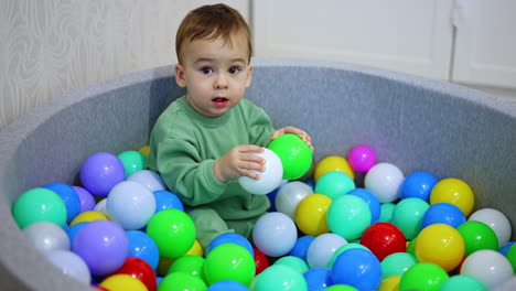 baby playing in a ball pit