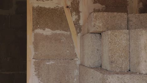 hempcrete bricks and wall interior in a construction site, panning left to right