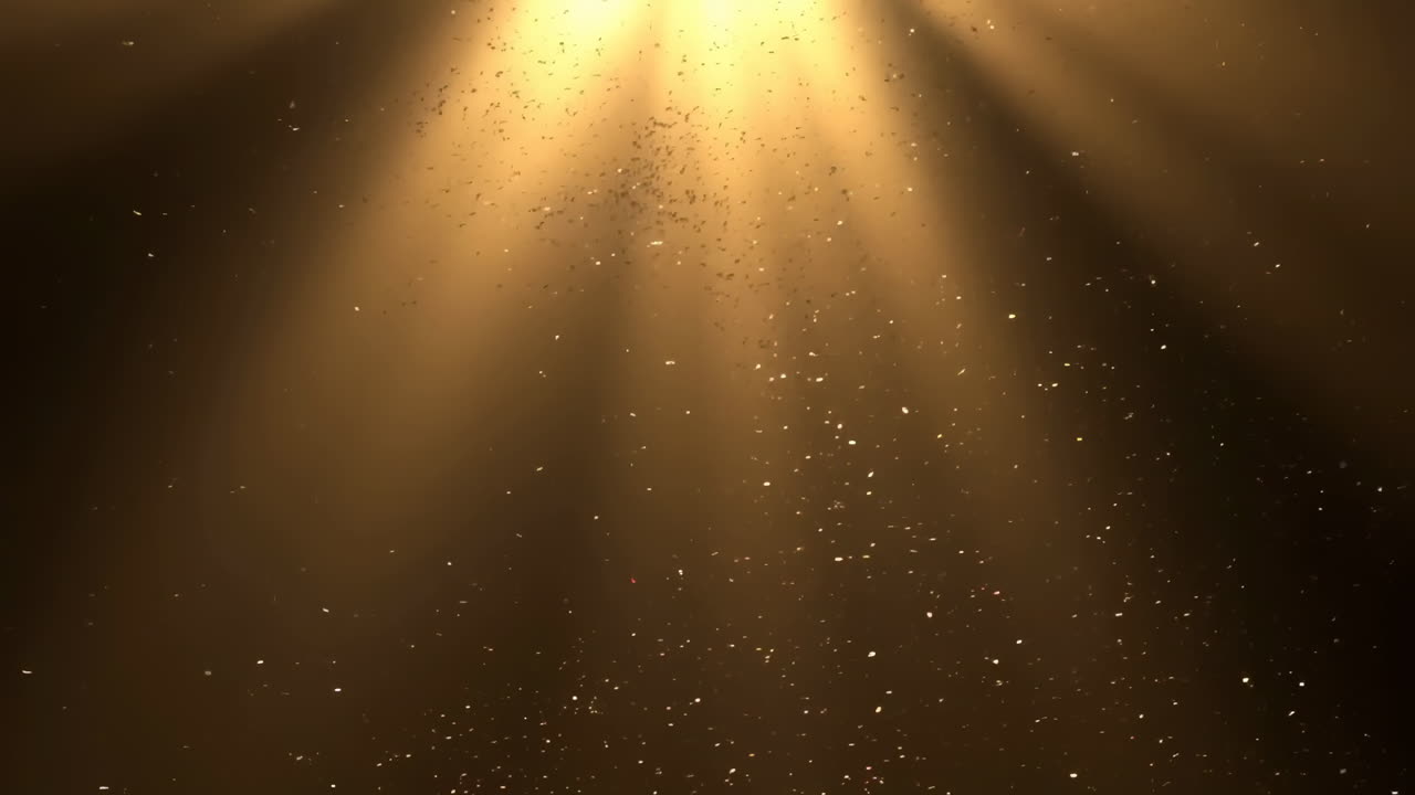Golden Light Rays Illuminating Falling Sparkling Particles