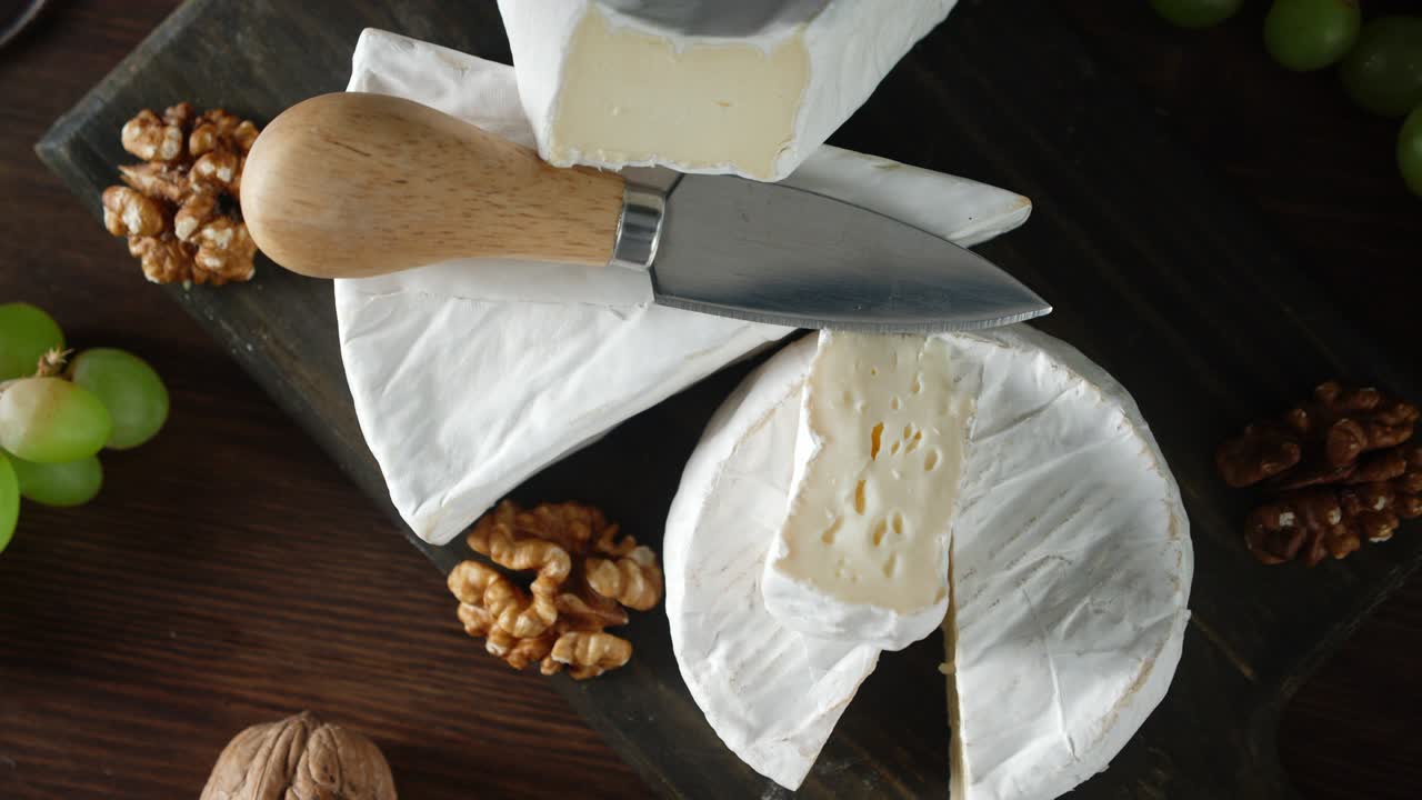 Fragrant Camembert cheese with walnuts slowly rotates.