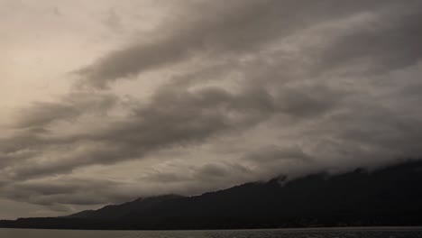 dramatic gray storm clouds criss cross lake quinalt olympic national forest, zoom out pan left
