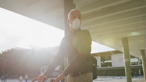 caucasian man out and about in the street wearing on a face mask against coronavirus