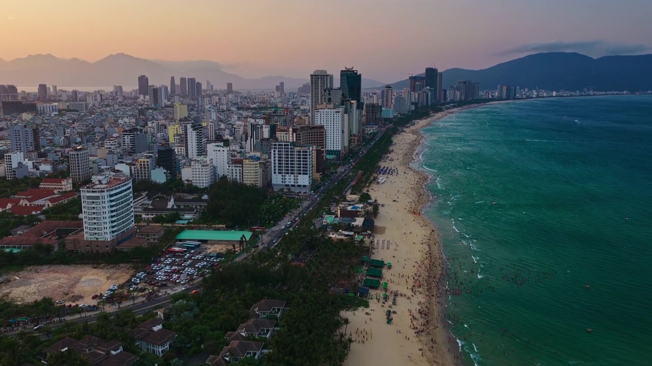 Cảnh quay drone bay trên không vào ban ngày về bãi biển cát vàng, đại dương xanh ngọc và các biệt thự nghỉ dưỡng sang trọng tại Đà Nẵng, Việt Nam