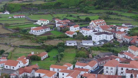 drone view of fajã grande town with waterfalls in background in azores portugal