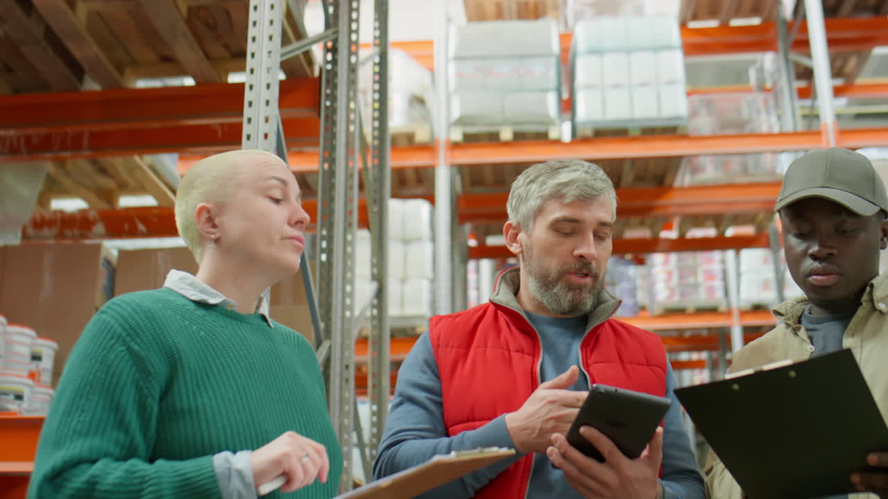 Diverse warehouse team collaborates on inventory and logistics