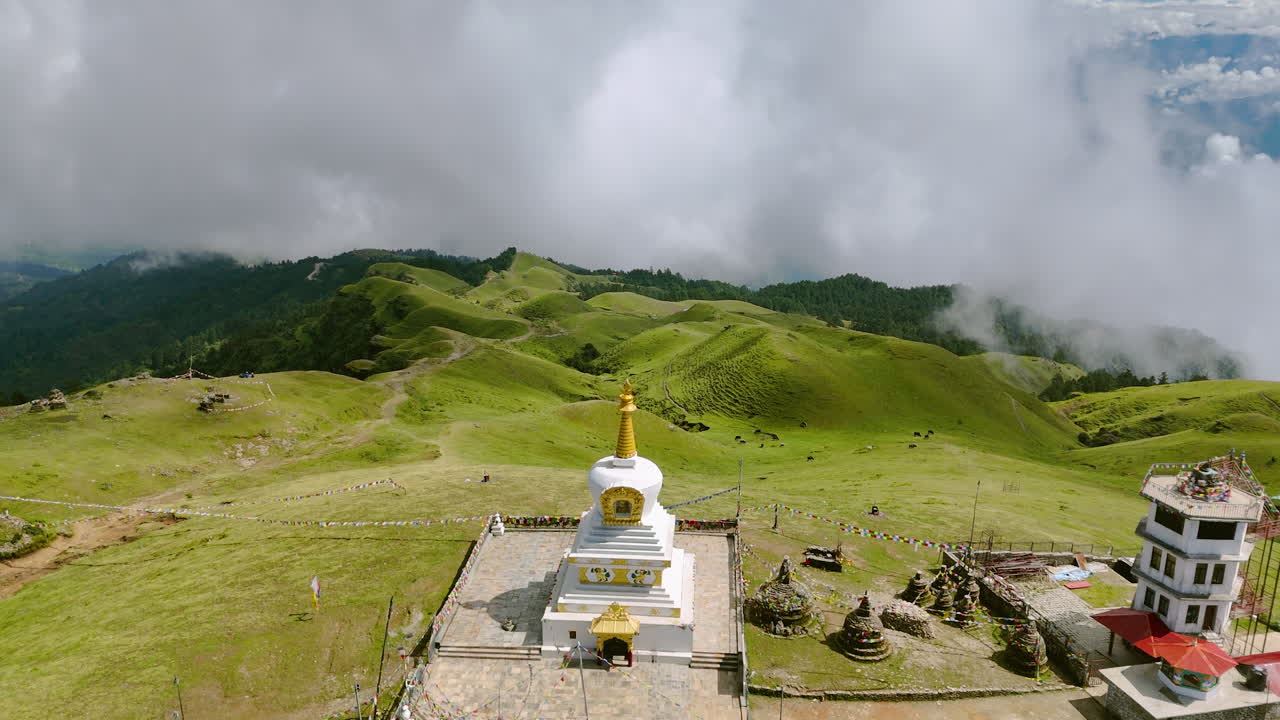 Green nature landscape of Nepal Drone shot with clouds and sunny environment of Stupa centered at the hills above forest and mountain landscape shows peaceful nature
