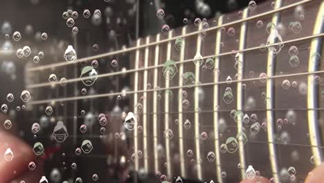 Digital-composite-video-of-humans-wearing-face-mask-icons-against-mid-section-of-man-playing-guitar-