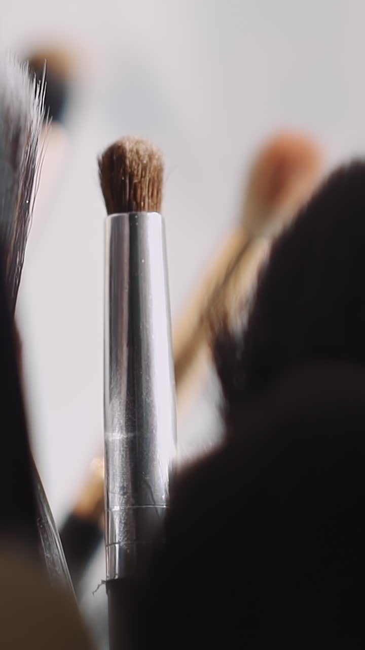 Large set of makeup brushes on workplace of professional visage master in beauty salon extreme closeup. Cosmetic tools to apply decorative cosmetics