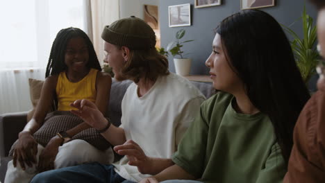 diverse group of friends socializing and laughing on a couch