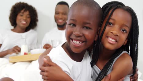 Children-hugging-each-other-on-bed