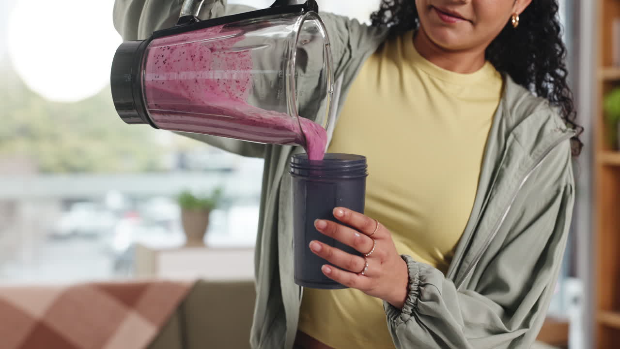 Woman Pouring Smoothie from Blender