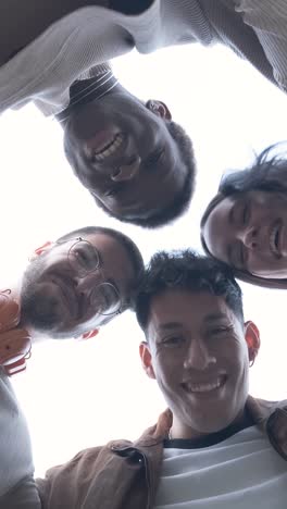 group of students of different ethnicities hugging each other in a circle