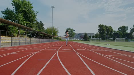 woman running and resting on a track