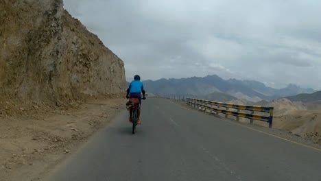 biker speeding on the mountain road to leh in ladakh, india - rolling shot